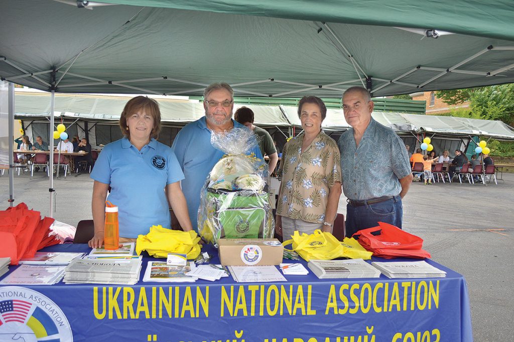 PERTH AMBOY, N.J. – The Ukrainian National Association was represented at this year’s Ukrainian Cultural and Heritage Festival in Perth Amboy, N.J., on Saturday, June 27. This annual event is sponsored by the Ukrainian Catholic Church of the Assumption of the Blessed Virgin Mary (established 1908). The UNA provided a hospitality booth for hundreds of guests who attended the festival. The UNA’s booth distributed complimentary gifts to children, as well as tote bags and UNA promotional literature highlighting insurance, annuity and endowment products. The UNA also helped to distribute and promote The Ukrainian Weekly and Svoboda. In addition, the UNA held a raffle for a picnic and cooler basket; hundreds came for the drawing. Seen in the photo above (from left) are: UNA’ers Marika Drich, Stephan Welhasch, Nancy Bohdan and Michael Bohdan.