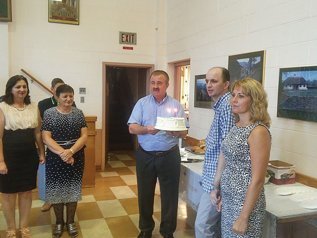 NEW HAVEN, Conn. – On Sunday, August 30, after the second divine liturgy, parishioners of St. Michael Ukrainian Catholic Church celebrated Roman Lutsiuk’s birthday. Mr. Lutsiuk has been in Connecticut since January. He was injured as a soldier in Ukraine and transferred to Yale New Haven Hospital because of his serious injuries. On this special day Mr. Lutsiuk’s wife, Tetiana, hosted the parishioners with a delicious birthday cake and wine. Father Iura Godenciuc wished Mr. Lutsiuk all the best and everyone sang “Mnohaya Lita.” The parishioners also gave him a nice gift. It was a joy for parishioners to be there on this special day, knowing how much Mr. Lutsiuk had gone through this year and seeing him smile. His two young daughters came to visit in August and had to return to Ukraine recently. – Halia Jurczak-Lodynsky