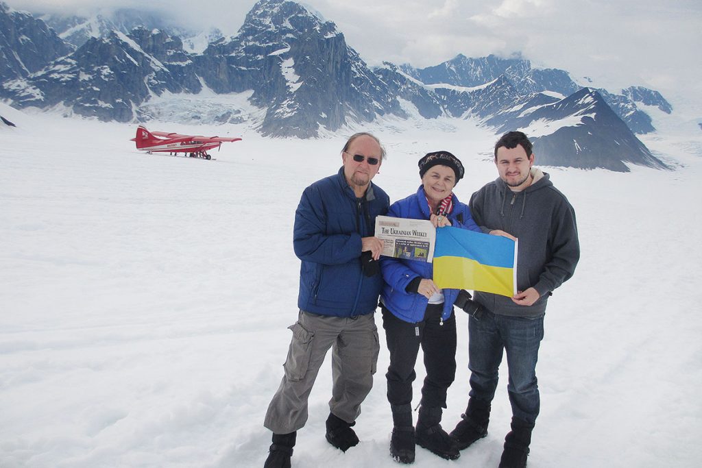 FOREST HILLS, N.Y. – George, Anisa and Maksym Mycak of Forest Hills, N.Y., display the Ukrainian flag and their latest issue of The Ukrainian Weekly during a June 20 “flightseeing” landing atop the Ruth Glacier, one of several glaciers on Alaska’s Denali (Mount McKinley), the highest peak in North America. Inspired by the displays of the Ukrainian flag by groups and individuals worldwide in support of the Euro-Maidan, the Mycaks have packed a Ukrainian flag for their travels since 2014. The landing site, called the Don Sheldon Amphitheater of the Ruth Gorge, is considered by some to be the most scenic spot in Denali National Park and Preserve, a vast territory encompassing more than seven million acres of interior Alaska.