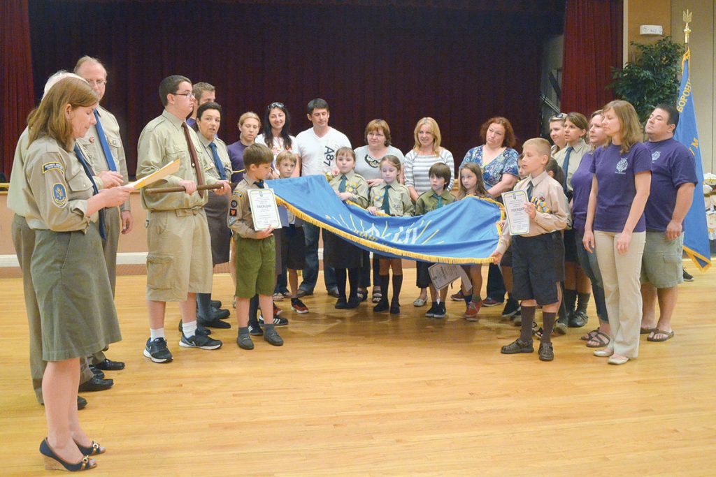 The Whippany, N.J., branch of the Ukrainian American Youth Association (UAYA) ended its 2014-2015 season with a ceremonial gathering on June 15. The children and branch board members donned their formal uniforms and ended their busy year with the children receiving the medals and certificates they had won at the “Zlet” competition held over the Memorial Day weekend in Ellenville, N.Y. The Whippany branch of UAYA, which is named in honor of August 24, 1991, took fifth place overall out of 18 branches represented at “Zlet.” Many children won gold, silver and bronze medals for their individual efforts in various events, including sports. The children who had reached their goals according to the UAYA handbook, took their oath, along with their parents, (as seen on the left) to uphold the ideals of the UAYA and to be honest and faithful citizens. A barbeque followed, allowing all families to enjoy each other’s company, as well as good food. – Christina I. Bytz